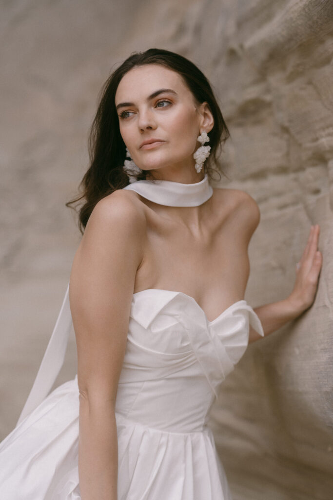 Bride dress in a luxurious silk dress on her elopement day at Amangiri.