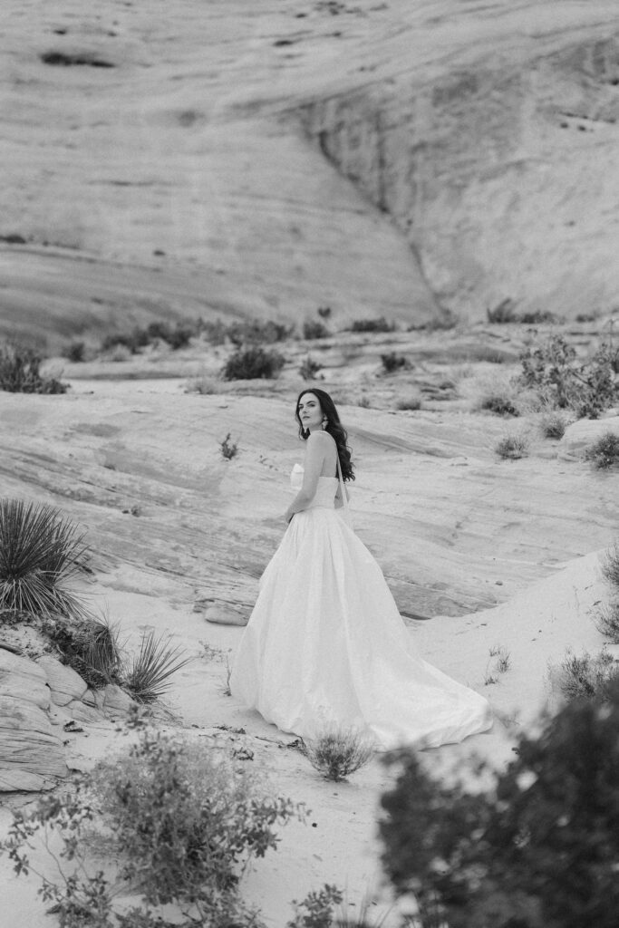 An intimate wedding in Utah's Amangiri. Bride dressed in a luxurious silk strapless wedding gown amongst the rock formations.  