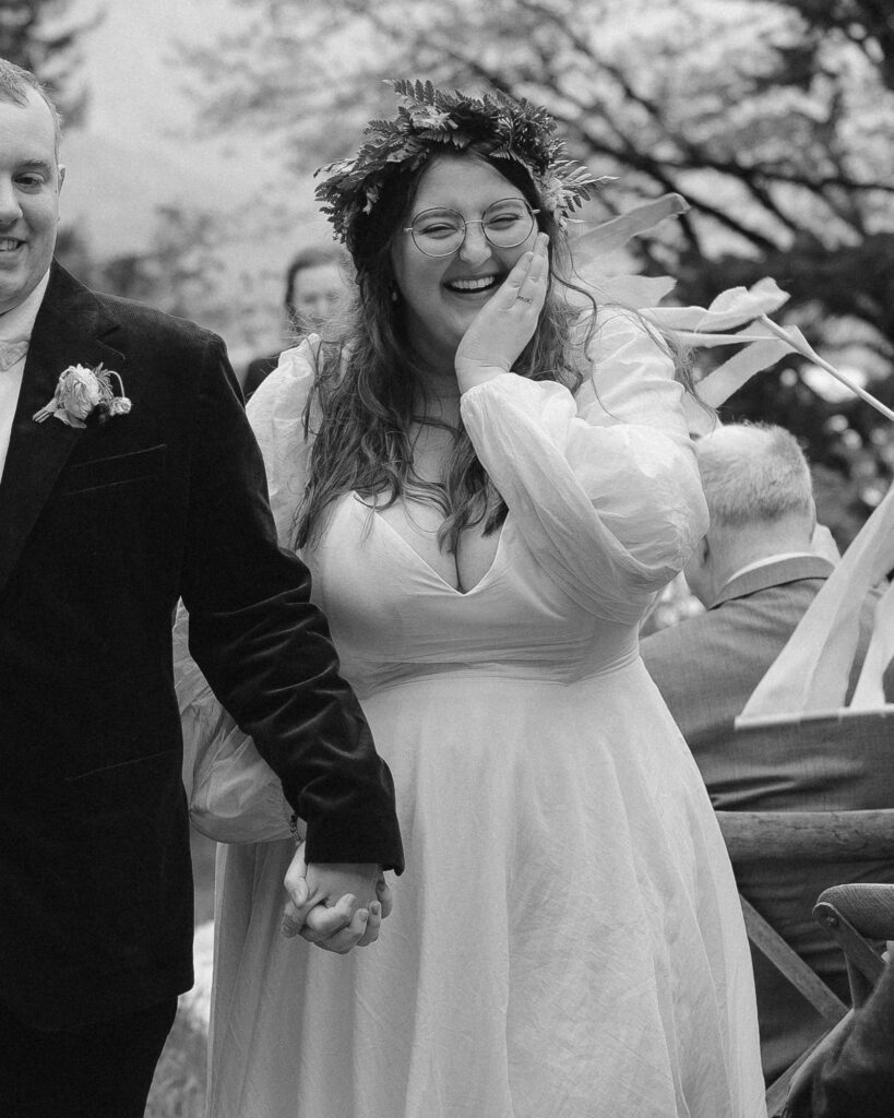 black and white portrait of bride's reaction during her wedding exit