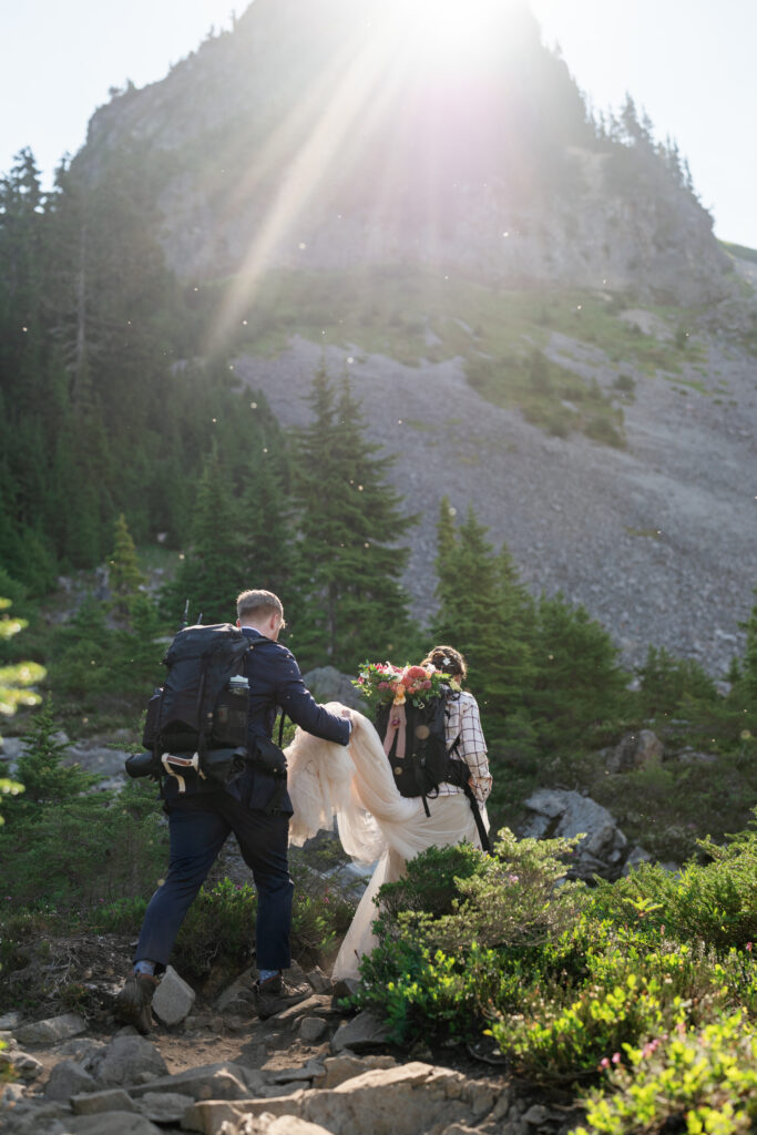 adventurous elopement couple hiking in wedding dress